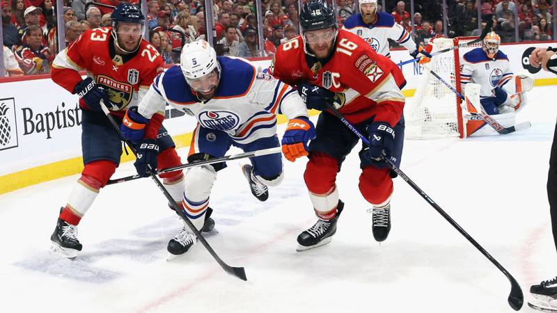 SUNRISE, FLORIDA - JUNE 08: Carter Verhaeghe #23 and Aleksander Barkov #16 of the Florida Panthers go up against Cody Ceci #5 of the Edmonton Oilers in Game One of the 2024 Stanley Cup Final at Amerant Bank Arena on June 08, 2024 in Sunrise, Florida.  (Photo by Bruce Bennett/Getty Images)