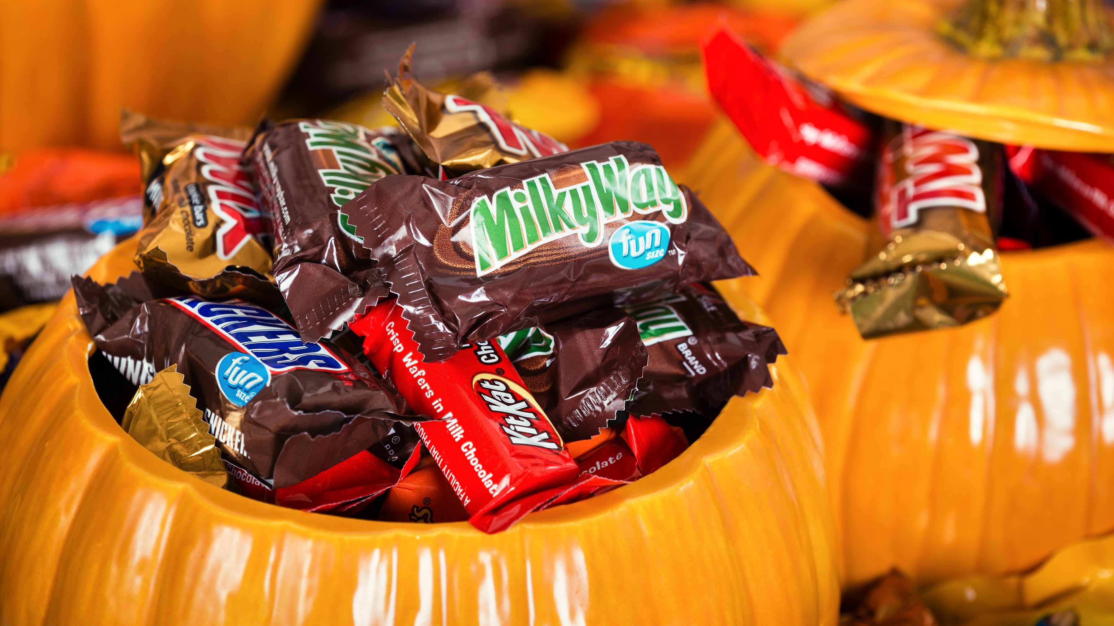 Decorative pumpkins filled with assorted Halloween chocolate candy made by Mars, Incorporated and the Hershey Company.